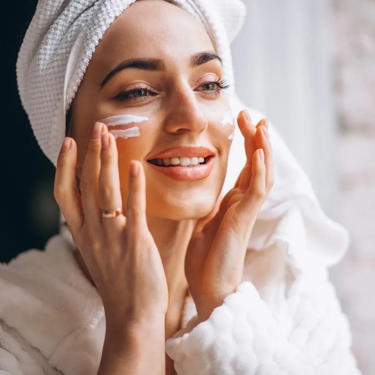 Skincare routine with woman in towel wrap