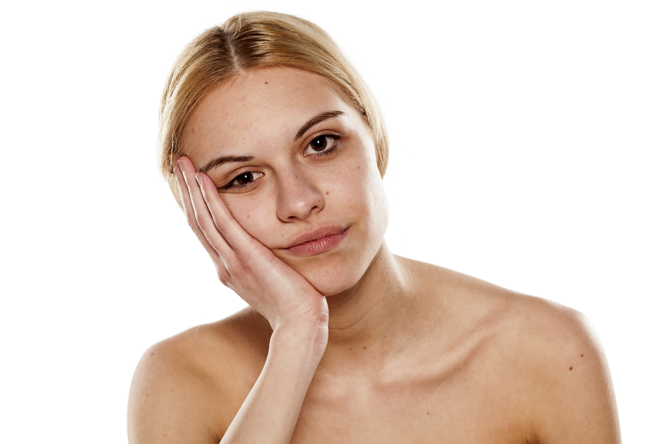 portrait of a young bored woman with no makeup on white background